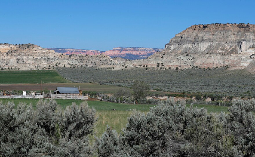 A farm sits at the foot of sandstone formations in the Grand Staircase-Escalante National Monument on May 11, 2017 outside Escalante, Utah.