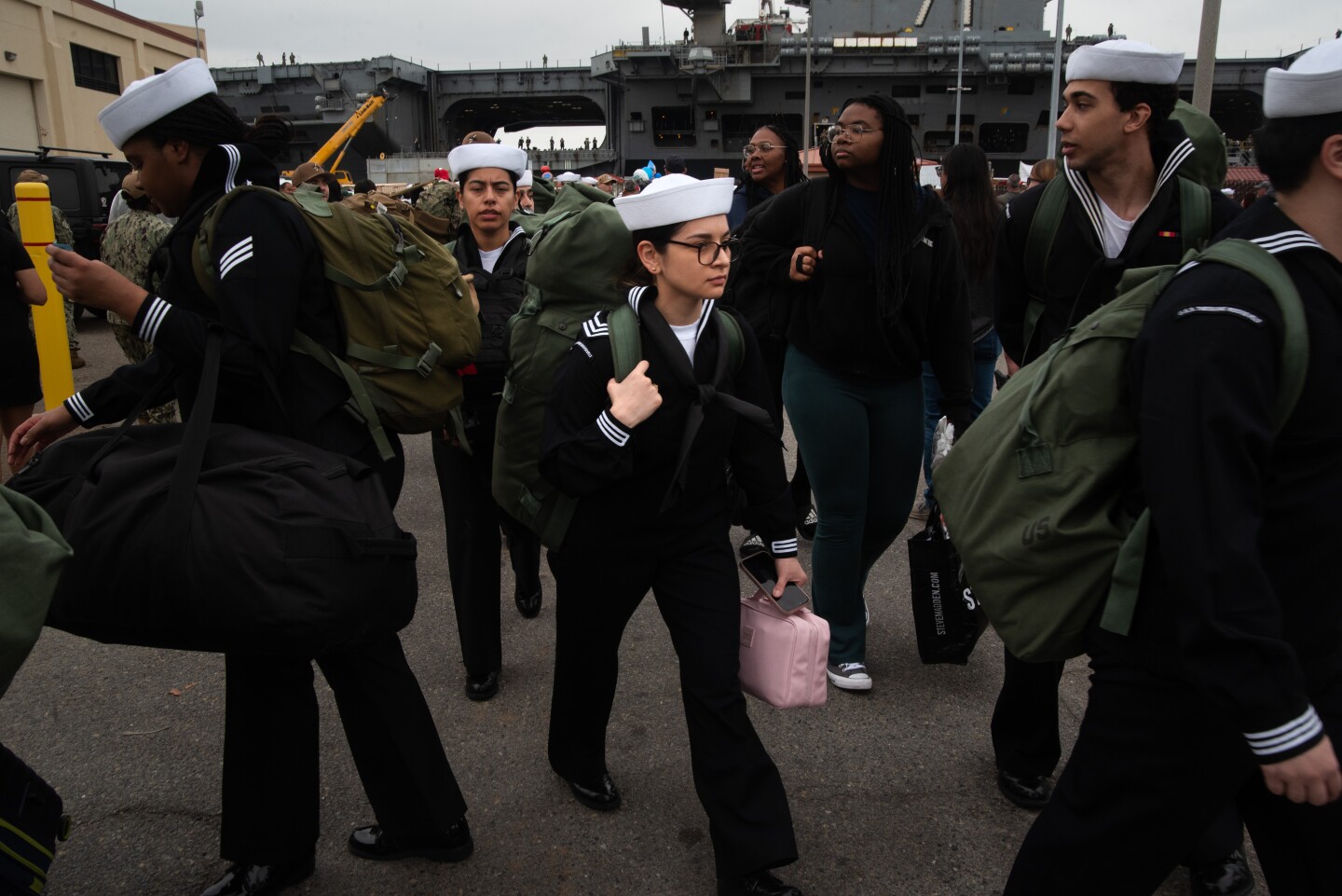 A sailor walks through the crowd after departing from the aircraft carrier Theodore Roosevelt on Oct. 15, 2024 at the Naval Air Station North Island on Coronado Island.