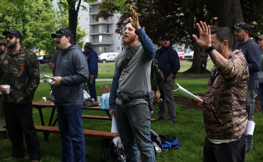 A Christian group sings songs in protest of the LGBTQ community's "Pride in the Park" event in Coeur d'Alene, Idaho.