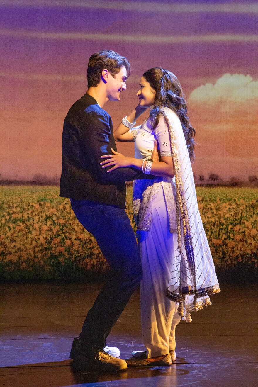 Austin Colby (Roger) and Shoba Narayan (Simran) are shown in a 2022 production photo for "Come Fall in Love – The DDLJ Musical" at The Old Globe.