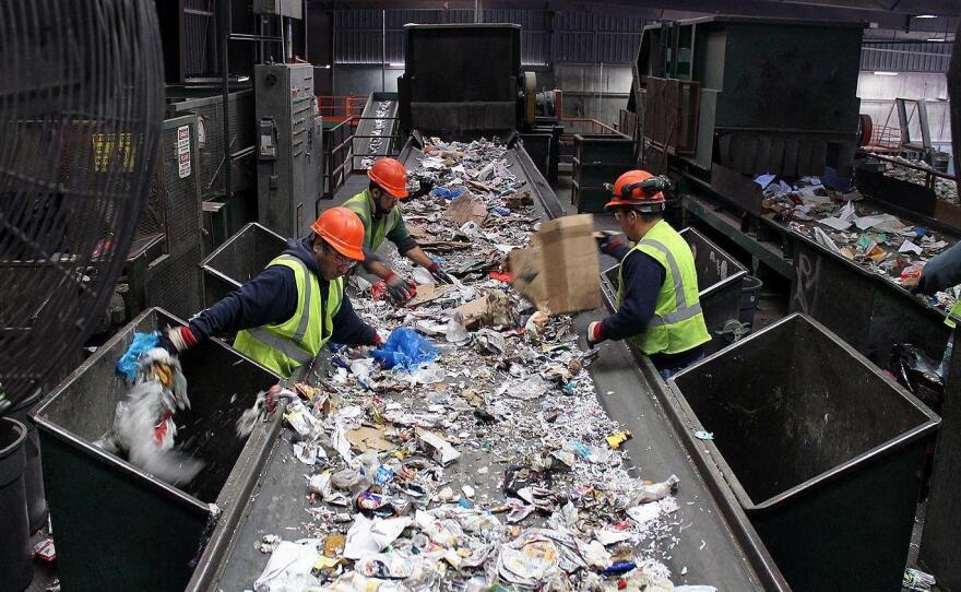 At Resource Management's Materials Recovery Facility, workers pull plastic bags, other trash and large pieces of cardboard off the conveyor belts before the mixed, single-stream recyclables enter the sorting machines.