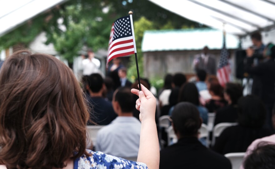 A child holds a U.S. flag at a naturalization ceremony at the Wyckoff House Museum in Brooklyn, on June 14, in New York City.