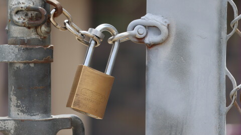 A padlock secures a fence at a school in Santee on Wednesday, Aug. 5, 2026.