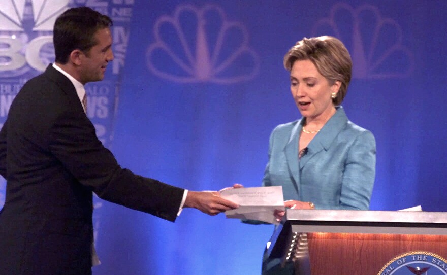 During a 2000 Senate debate, Hillary Clinton's opponent Rick Lazio, R-N.Y., hands her a pledge to stop taking "soft money." But Lazio's tone was criticized for how not to debate a female candidate.