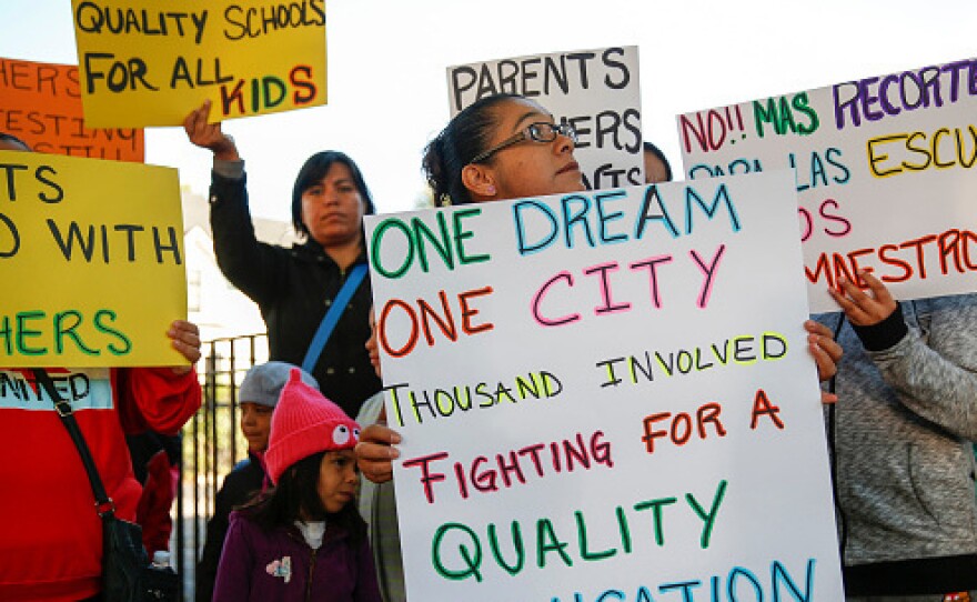 Parents, students and supporters of Chicago Public Schools teachers gather at a press conference in 2016 near Mayor Rahm Emanuel's home.