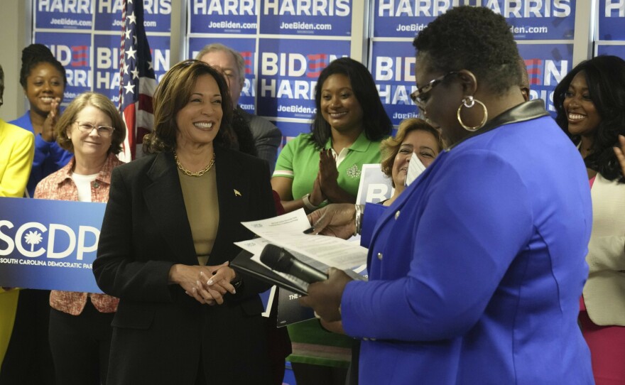 Vice President Harris smiles as South Carolina Democratic Party chair Christale Spain accepts President Biden's paperwork for the state's Democratic presidential primary.