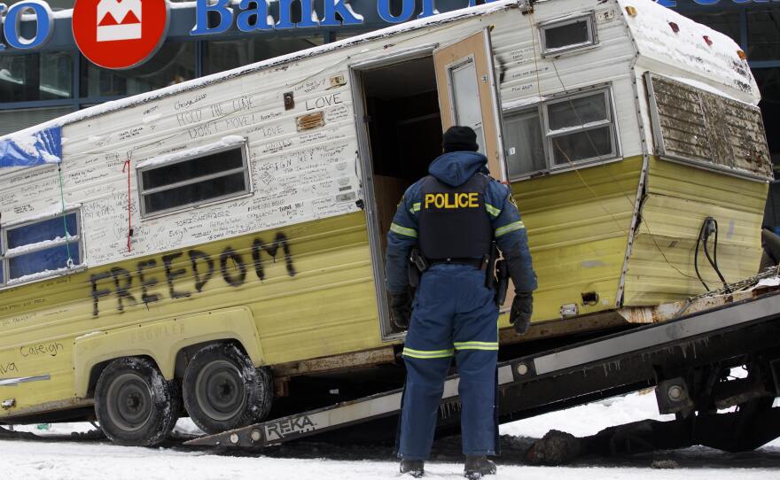 A camper is towed away by authorities clearing a trucker protest that was aimed at COVID-19 measures in Ottawa on Sunday.