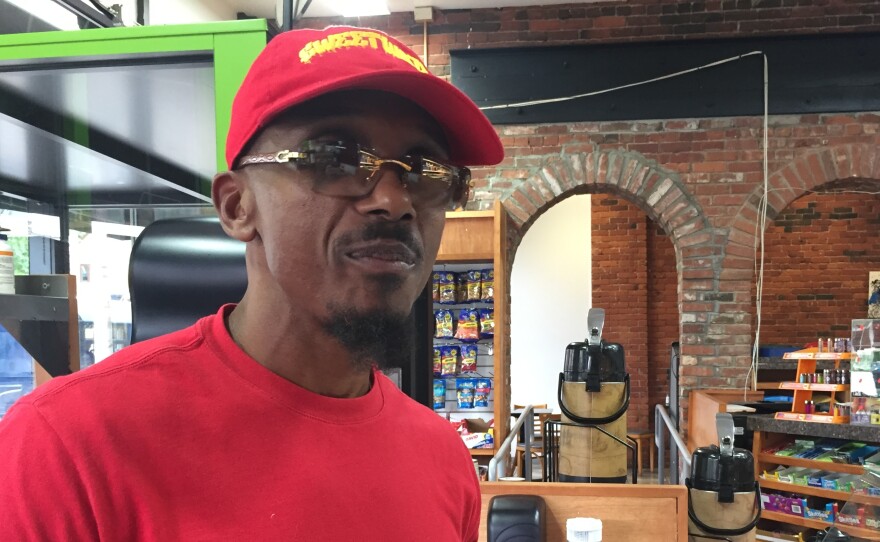 Mark Schand scoops ice cream at his Sweetwater smoothie cafe in New Britain, Conn. This business is meant to reboot a career Schand says was stolen from him at the age of 19 when he was wrongfully convicted of a crime and was imprisoned for 27 years.
