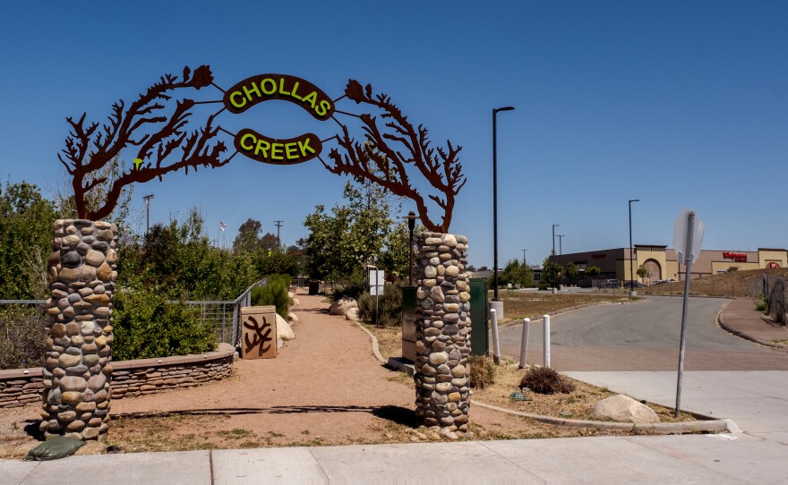 An archway entrance to Chollas Creek Park leads to a dirt walking trail, April 19, 2022.