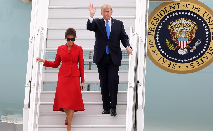 President Trump and first lady Melania Arrive At Orly Airport on Thursday in Paris. Trump told reporters on Air Force One that he was considering tariffs on steel imports.