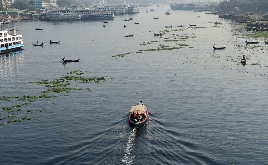 Bangladeshi commuters use boats to cross the Buriganga River in the capital Dhaka in 2018. In July, Bangladesh's top court granted all the country's rivers the same legal rights as humans.