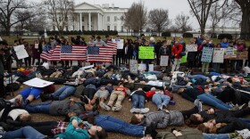 Demonstrators participate in a "lie-in" during a protest in favor of gun control reform in front of the White House in Washington, Monday, Feb. 19, 2018. 
