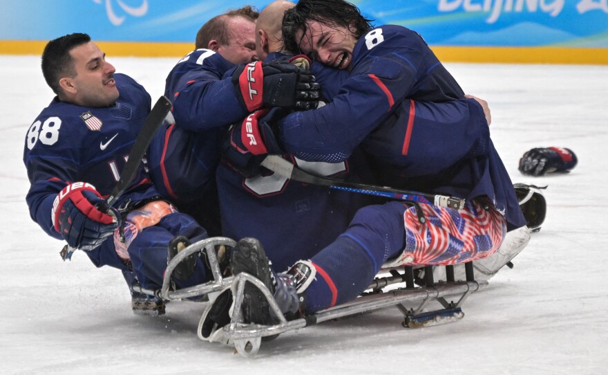 Team USA celebrates after winning the para ice hockey final match between the U.S. and Canada.