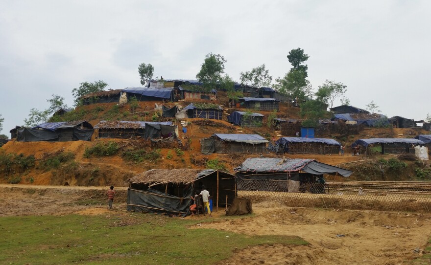 Small huts have been scraped out of the hillsides of the Balukali camp. Homes have blue plastic sheeting for walls, and roofs that are held together by thin strips of bamboo.