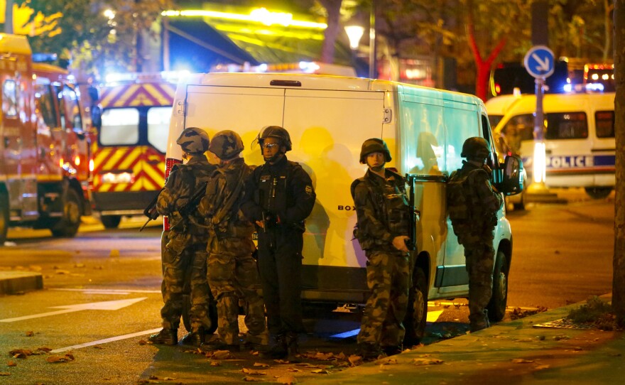 Law enforcement officers gather outside the Bataclan, where people inside were being held hostage.