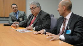 In this undated photo, Senator Calderon (center) reviews information regarding the Rancho Los Amigos Rehabilitation Center.