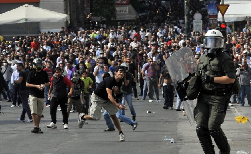 Anti-riot police clash with Greek demonstrators in Athens in October during a protest against deeper austerity cuts, as the debt crisis in Greece and the rest of Europe intensified this year.