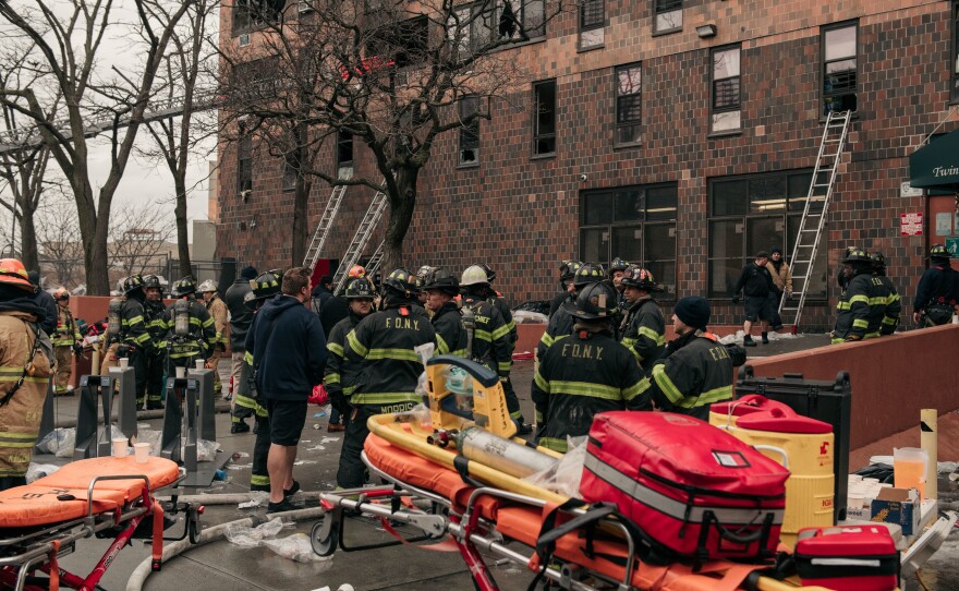 Emergency first responders remain at the scene of an intense fire at a 19-story residential building that erupted in the morning on Jan. 9, 2022 in the Bronx borough of New York City.