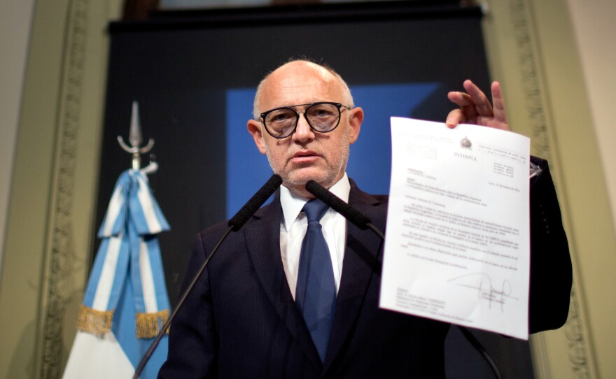 Argentina's Foreign Minister Hector Timerman on Jan. 15 shows a letter he said was sent in 2013 to Interpol informing it of an agreement reached with Iran's government to investigate the 1994 bombing of the Argentine-Israeli Mutual Association that killed 85 people. Timerman says he met with Iran in an attempt to solve the case and denied accusations he was part of a coverup.