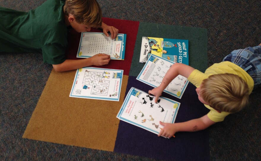 Two young boys complete Dr. Seuss-related activity pages at the UC San Diego Geisel Library celebration of the new book, July 28,2015.