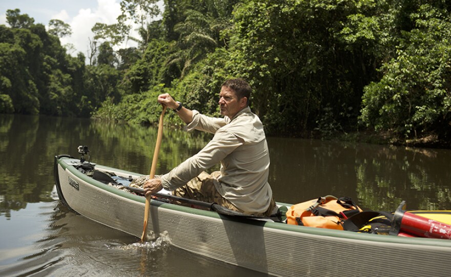 Steve rows his inflatable boat on the unnamed river. Suriname.