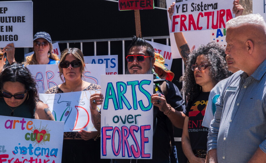 Protesters opposed to San Diego Mayor Todd Gloria's budget cuts to arts programs gather at San Diego's Civic Center Plaza before a City Council meeting on April 20, 2026.