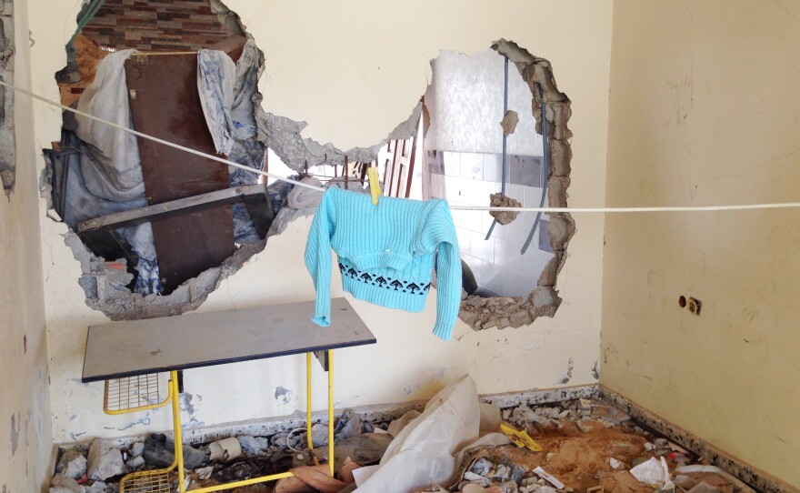 Laundry hangs between blown out walls in the Otaish family's four-story home.