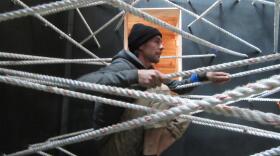 Artist Wes Sam-Bruce climbing ropes in his immersive exhibit, "The Wonder Sound," at the New Children's Museum.