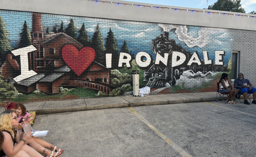 Festival-goers sit outside Irondale, Alabama's city hall on I Love Irondale Day, July 18, 2026.