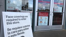 A sign advising of the store's COVID-19 prevention policies sits outside Target in the South Park neighborhood of San Diego County. Jan. 26, 2021. 
