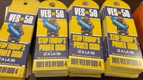 Door hangers in support of Prop 50. They read "Stop Trump's Power Grap" and "Alto al abuso de poder de Trump"