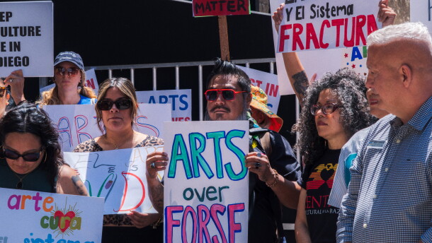 Protesters opposed to San Diego Mayor Todd Gloria's budget cuts to arts programs gather at San Diego's Civic Center Plaza before a City Council meeting on April 20, 2026.