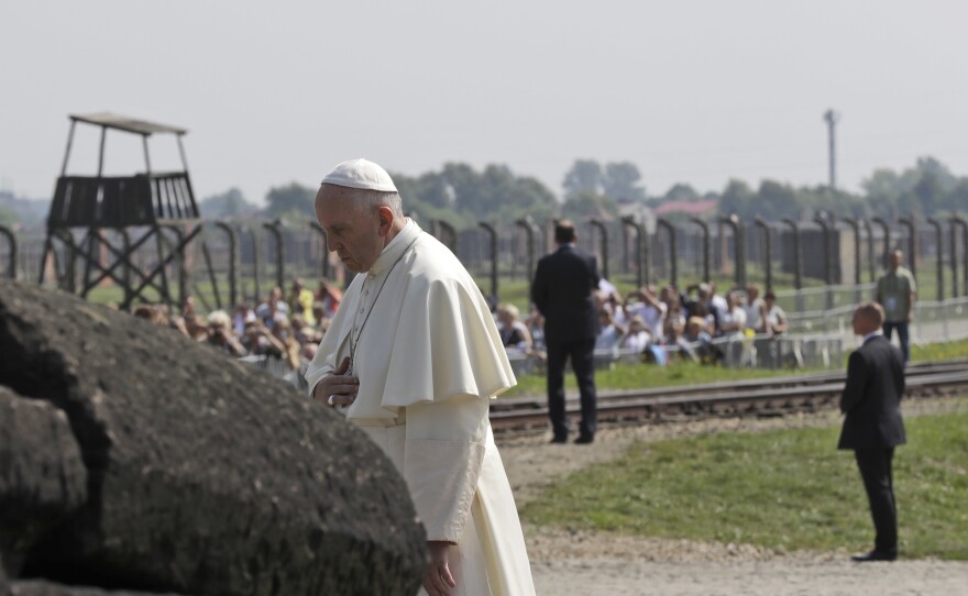 Pope Francis prays in front of the memorial at Auschwitz-Birkenau on Friday.