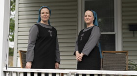 Sister Danielle Lussier and Sister Theresa Alethia pose for a portrait on the front porch of their home in Mt. Sterling, Ky., in April.