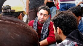 Hassan Issa grieves for his father, Issa  Abdel Hassan, who was killed Thursday morning. "I was supposed to be the martyr, not  him," the son said. He said they had been making their way to  Pearl Square, where police had charged in with tear gas, clubs and other  weapons, when his father was shot by police.