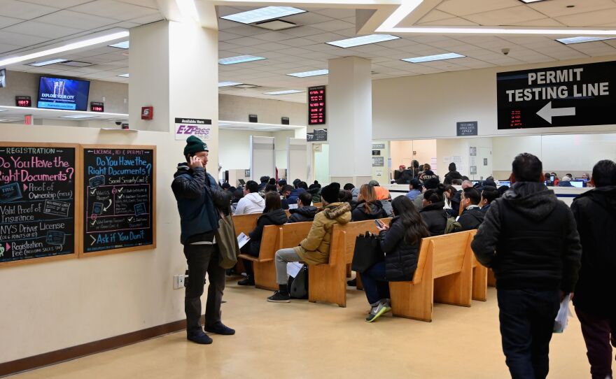 DMV offices around the U.S. were slowed down for hours on Monday, due to a network outage in a key database. Here, people wait at the New York State Department of Motor Vehicles office in  Brooklyn last month.