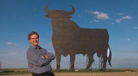 Rick Steves stands beside his favorite bull board, Spain. 