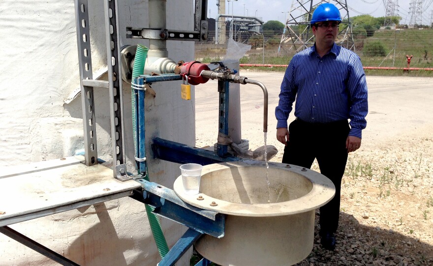 Tomer Efrat, a manager at IDE Technologies, stands near a tasting faucet at the Hadera desalination plant.