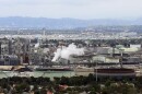This file aerial photo shows the Standard Oil Refinery in El Segundo, Calif., with Los Angeles International Airport in the background and the El Porto neighborhood of Manhattan Beach, Calif., in the foreground, May 25, 2017.