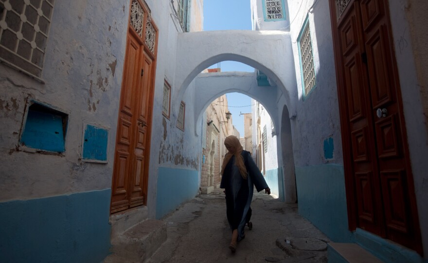 A woman walks the narrow streets of the old city in Kairouan, Tunisia.