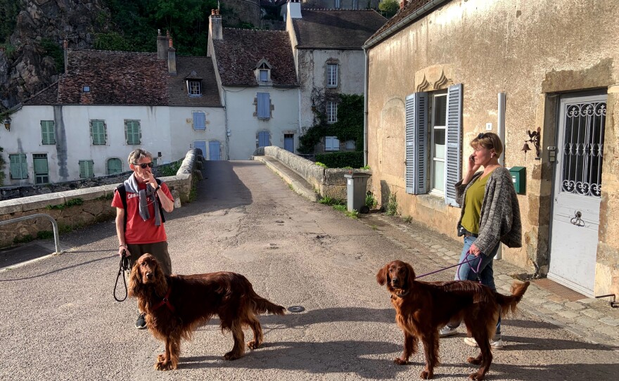 Yuri Mazurenko and Macha Levitin get ready to go on a walk with their dogs Rolly and Safra in a village in Burgundy, France.