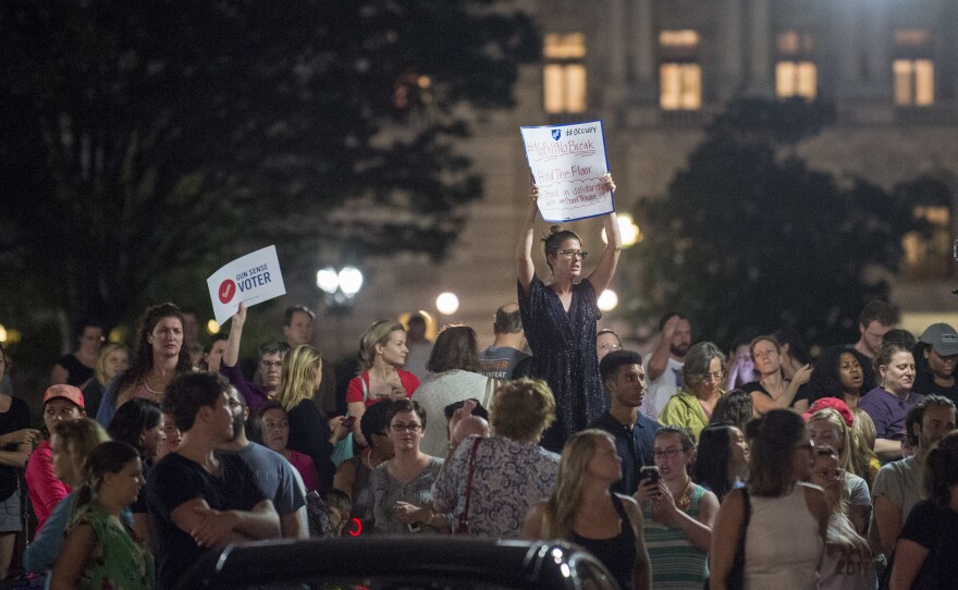 Supporters of House Democrats taking part in a sit-in in the House Chamber shout encouragement from outside the U.S. Capitol on Wednesday night.