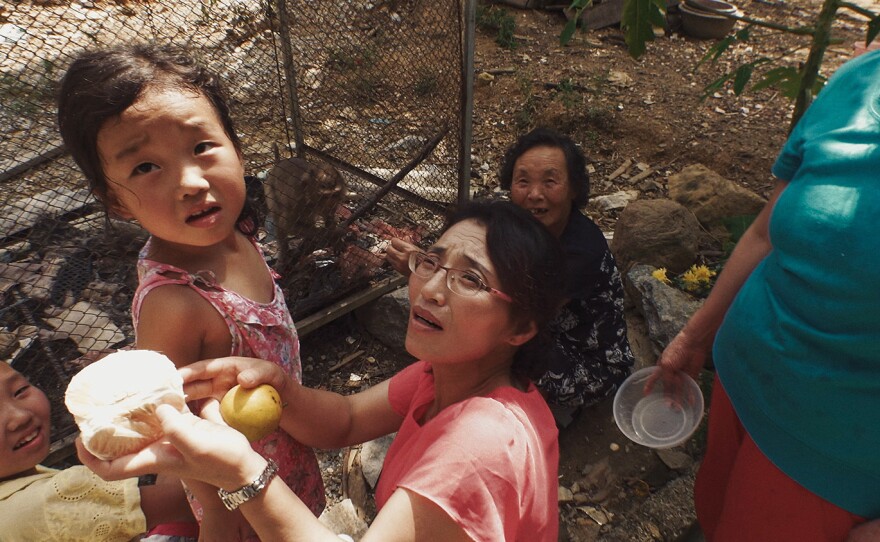 The Roh family feds monkeys in Laos.