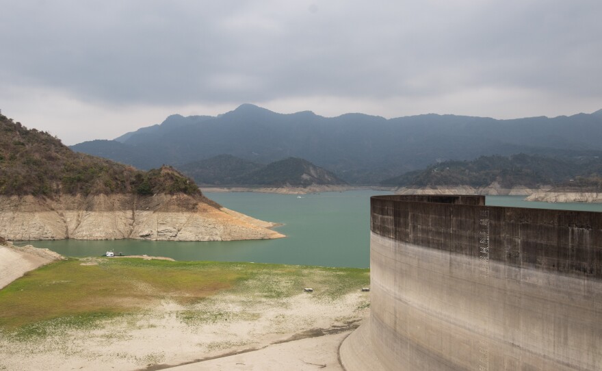 The Zengwen reservoir earlier in April. Low rainfall means it is filled at just 11% capacity this month. Its low water levels are ringed by a thick band of white – parched dry land left as the water recedes.