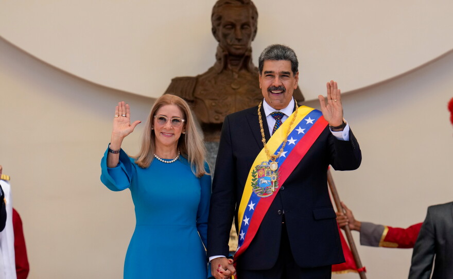 FILE - Venezuelan President Nicolas Maduro and his wife Cilia Flores wave after his swearing-in ceremony for a third term at the National Assembly in Caracas, Venezuela, on Jan. 10, 2025.