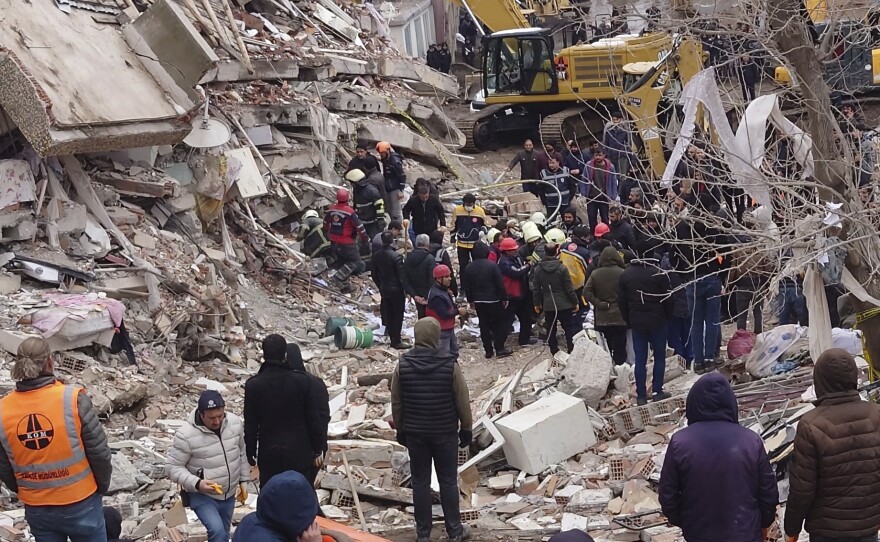 Rescue workers search for survivors under the rubble of a collapsed building in Diyarbakir, southeastern Turkey, on Monday. A powerful earthquake struck southeast Turkey and northern Syria.