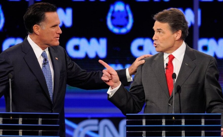 <p>Former Massachusetts Gov. Mitt Romney (left) and Texas Gov. Rick Perry got into a heated exchange about immigration during Tuesday's GOP presidential debate in Las Vegas.</p>