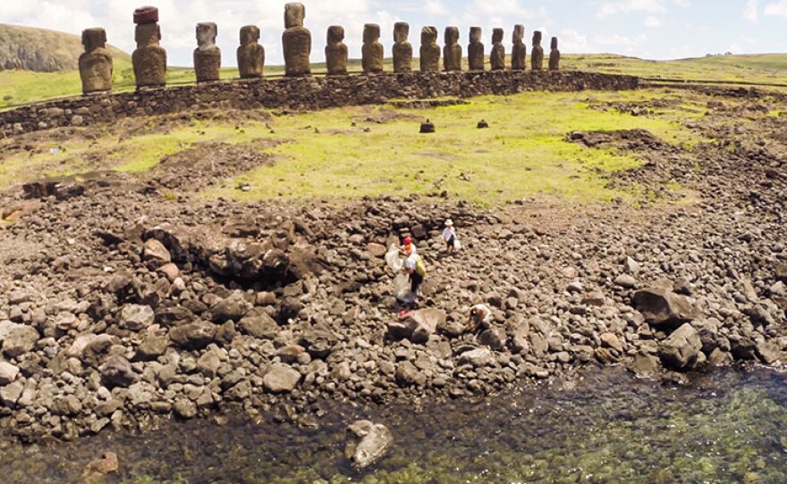 Mama Piru and her husband Francis clean microplastics behind Ahu Tongariki on Rapa Nui.