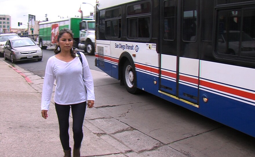 Eva Luna gets off the bus on University Avenue and then begins walking another 1.5 miles to get to work, May 6, 2015.