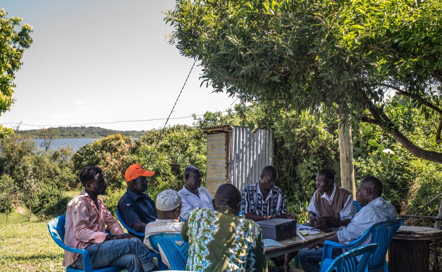 A meeting of another rotating savings club in the same village, this one founded by Denis Otieno (third from the right). People who were promised the monthly income grants for 12 years used such clubs at an astonishing rate – contributing nearly 70% more money than those in the control group that got no aid.